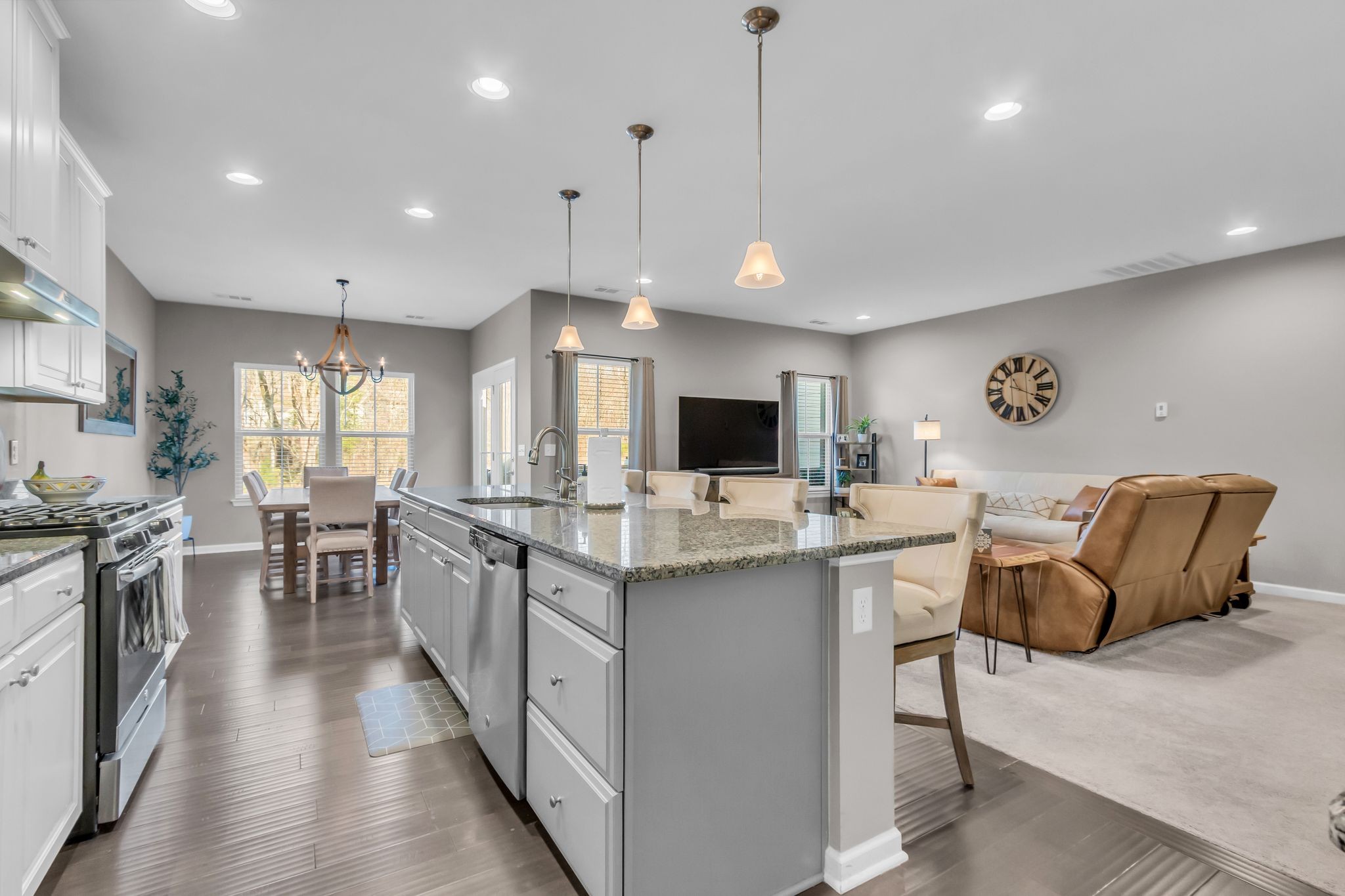 6930 Wellsford Lane College Grove, TN 37046 - Photo 14 of 44 a kitchen with stainless steel appliances granite countertop a stove top oven a sink dishwasher a dining table and chairs with wooden floor