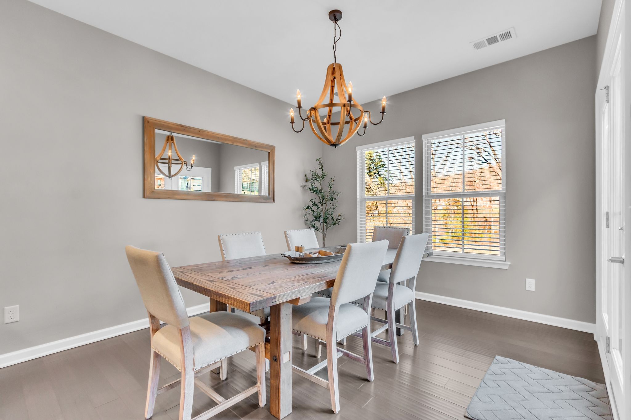 6930 Wellsford Lane College Grove, TN 37046 - Photo 15 of 44 a dining room with wooden floor a chandelier a wooden table and chairs
