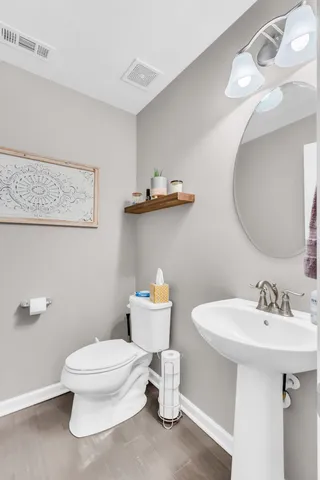 a bathroom with a sink a toilet and mirror