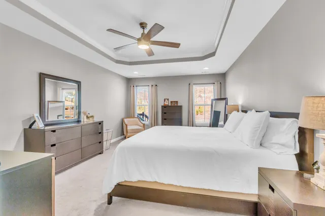 a bedroom with a large bed and a chandelier