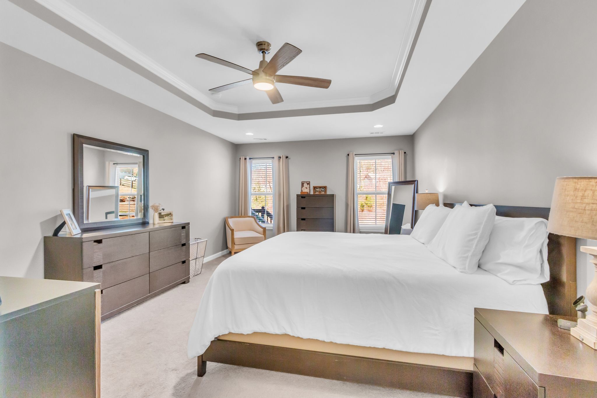 6930 Wellsford Lane College Grove, TN 37046 - Photo 19 of 44 a bedroom with a large bed and a chandelier