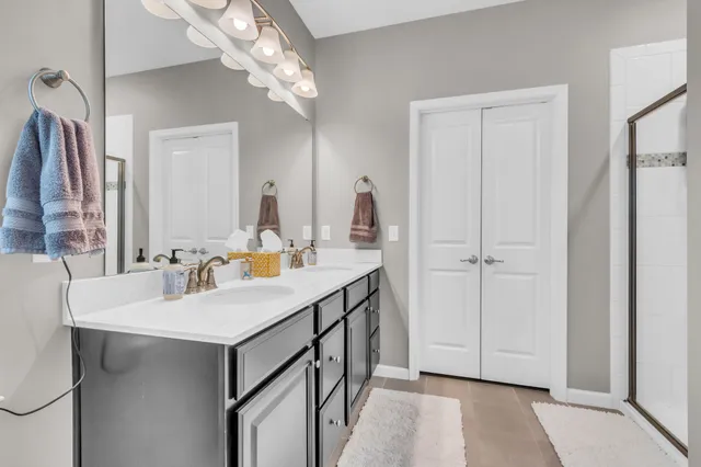 a bathroom with a sink vanity and a mirror