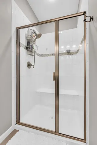a bathroom with a glass shower door