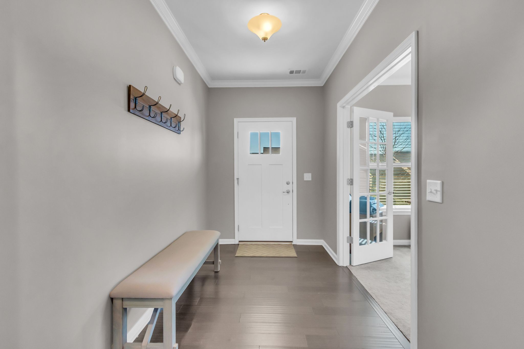 6930 Wellsford Lane College Grove, TN 37046 - Photo 3 of 44 a view of a hallway with wooden floor and a bathroom