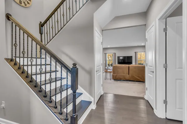 a view of entryway and hall with wooden floor
