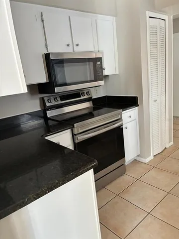 a stove top oven sitting inside of a kitchen