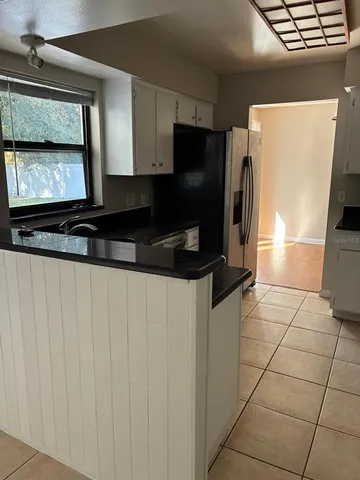 a kitchen with stainless steel appliances a refrigerator sink and microwave