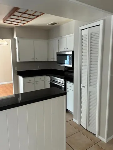 a kitchen with stainless steel appliances a refrigerator and a stove