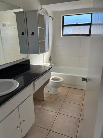 a bathroom with a double vanity sink a mirror and a bathtub