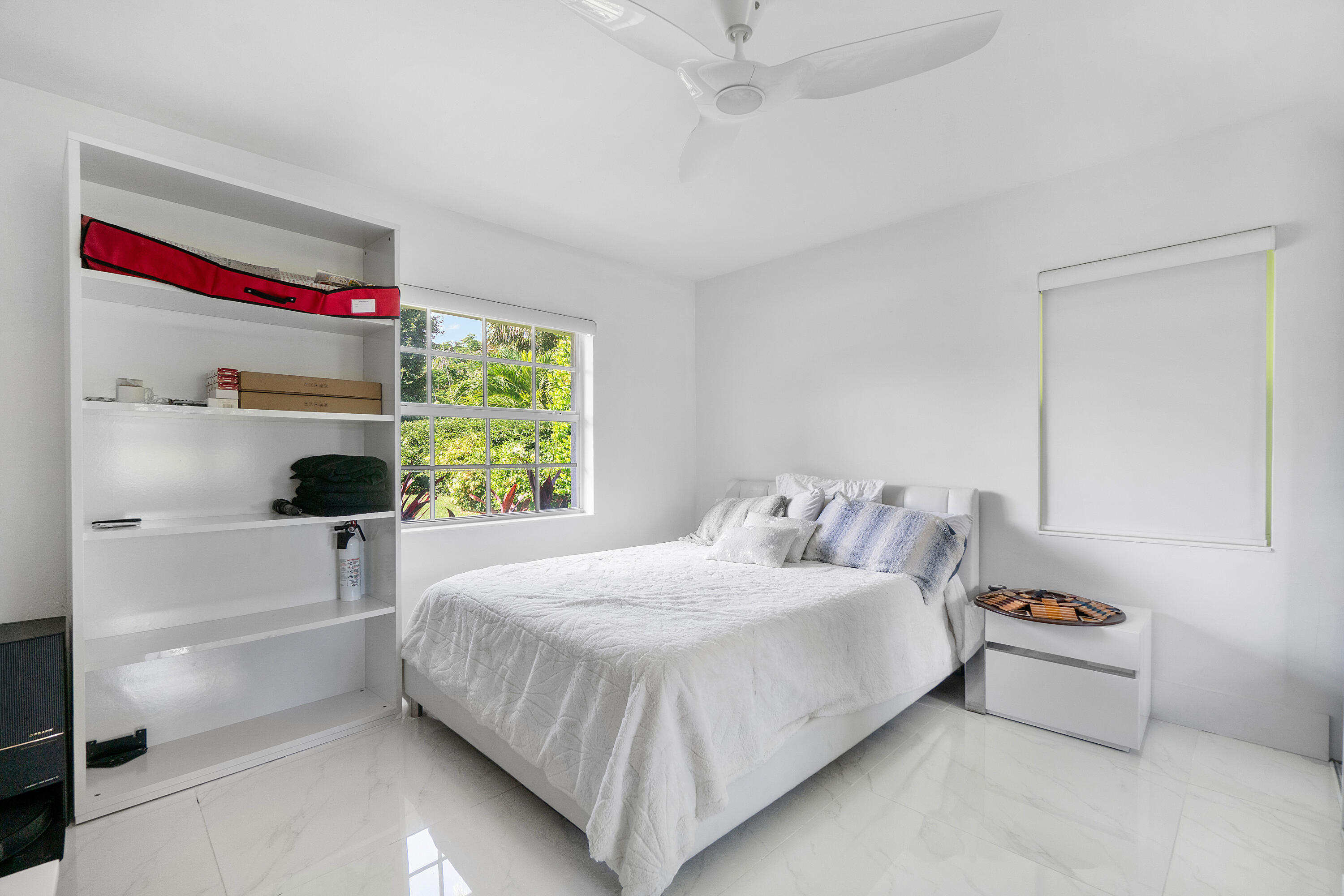 5447 Center Street Jupiter, FL 33458 - Photo 23 of 60 a bedroom with a bed and a window