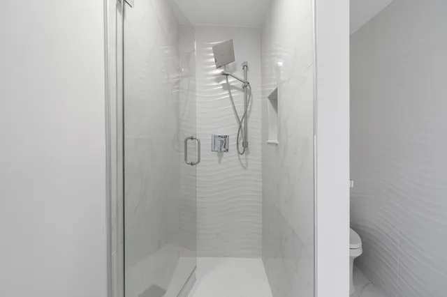 a bathroom with a granite countertop toilet and a sink