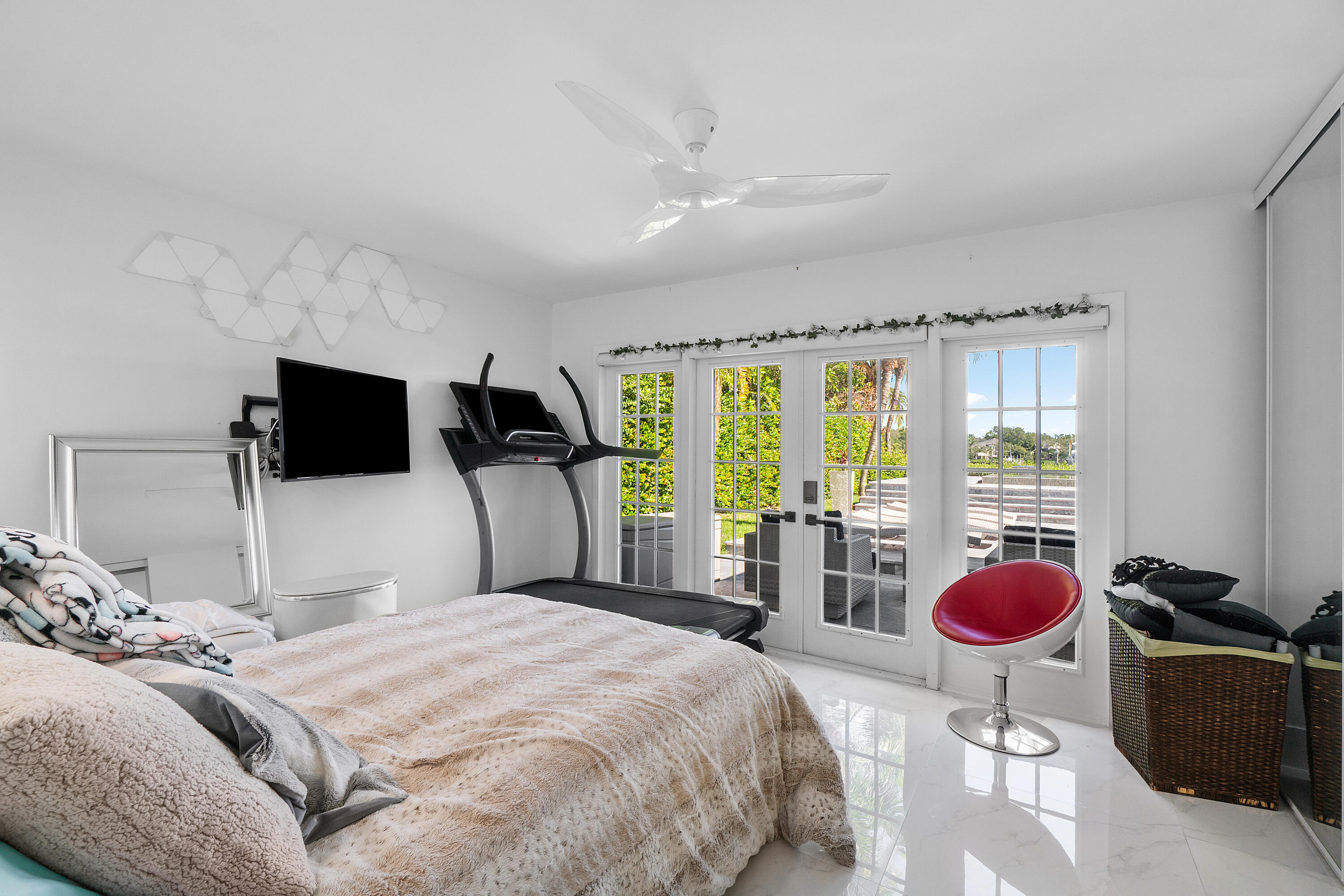 5447 Center Street Jupiter, FL 33458 - Photo 28 of 60 a bedroom with a bed and large windows