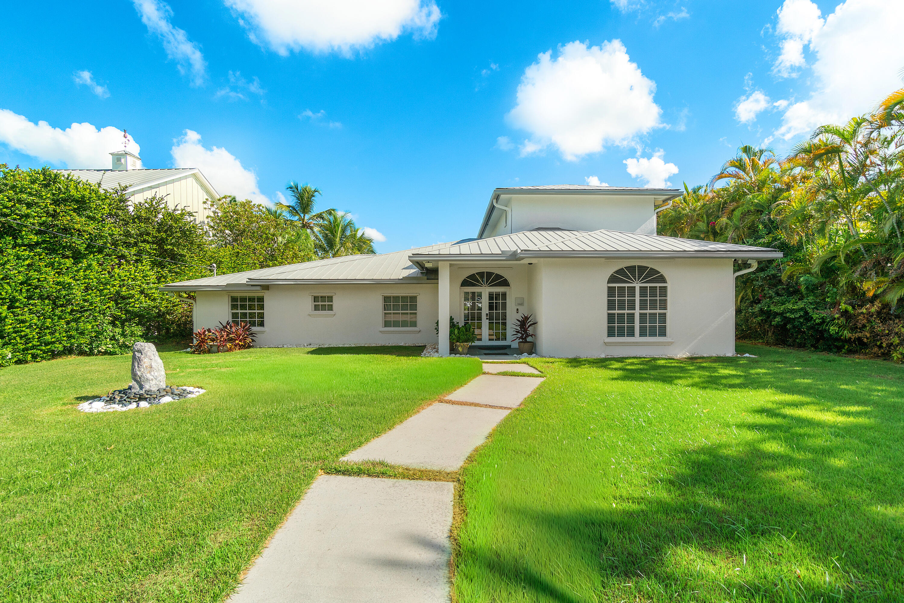 5447 Center Street Jupiter, FL 33458 - Photo 4 of 60 a aerial view of a house with a yard and porch