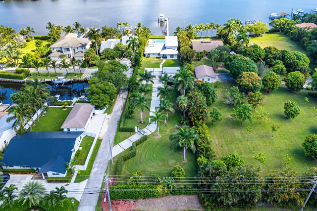 an aerial view of a swimming pool with lawn chairs