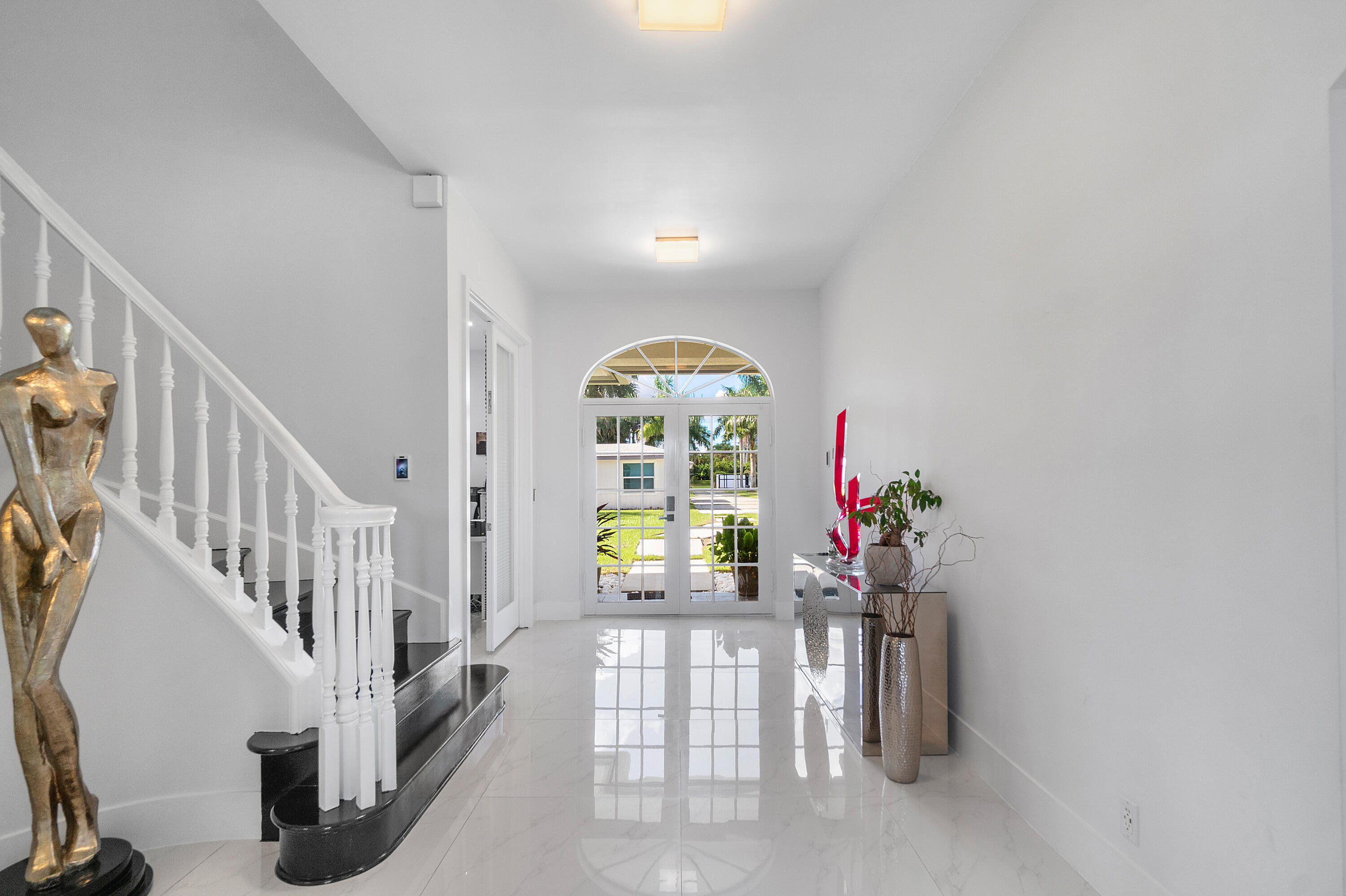 5447 Center Street Jupiter, FL 33458 - Photo 5 of 60 a view of entryway with wooden floor