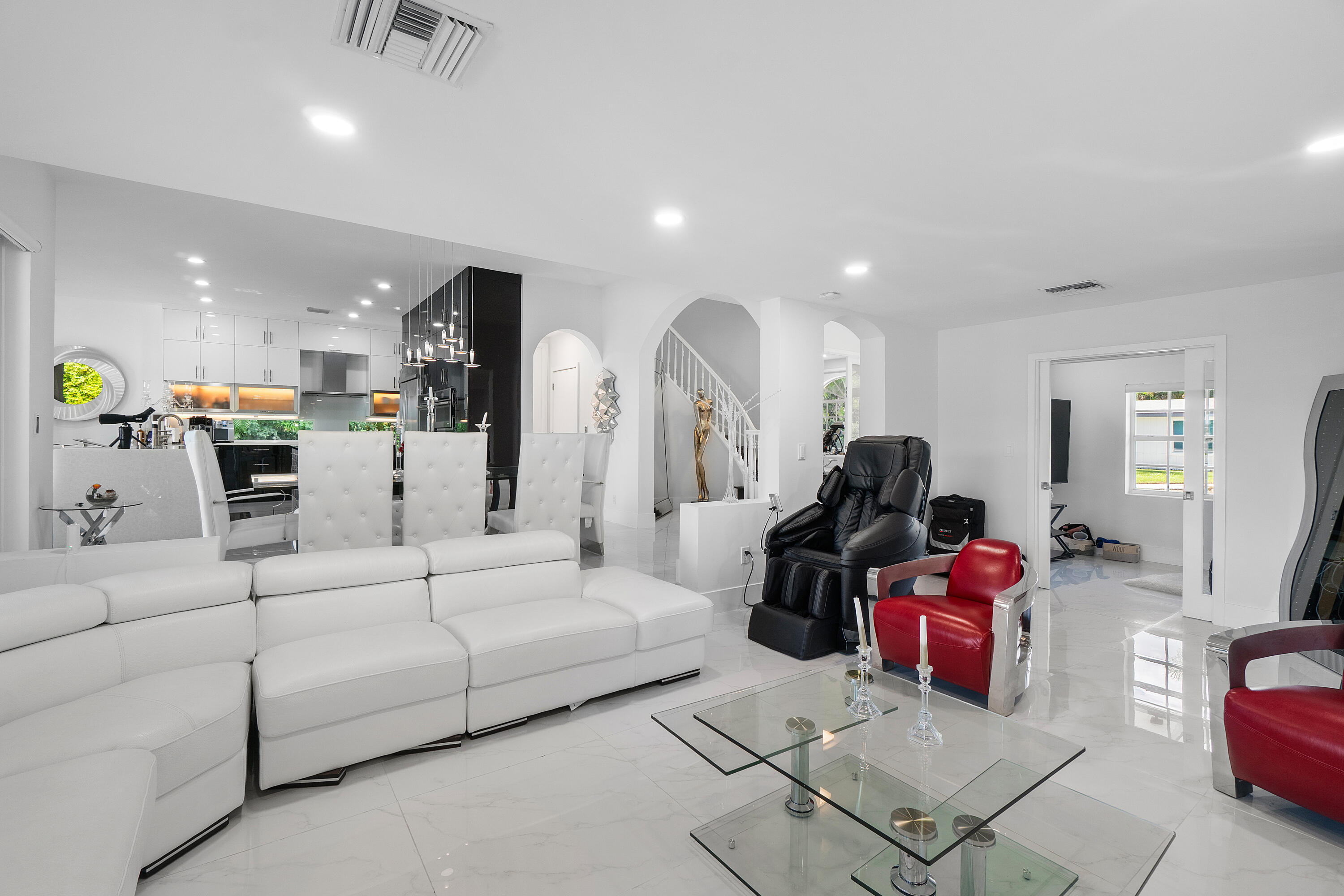 5447 Center Street Jupiter, FL 33458 - Photo 9 of 60 a living room with furniture and a chandelier