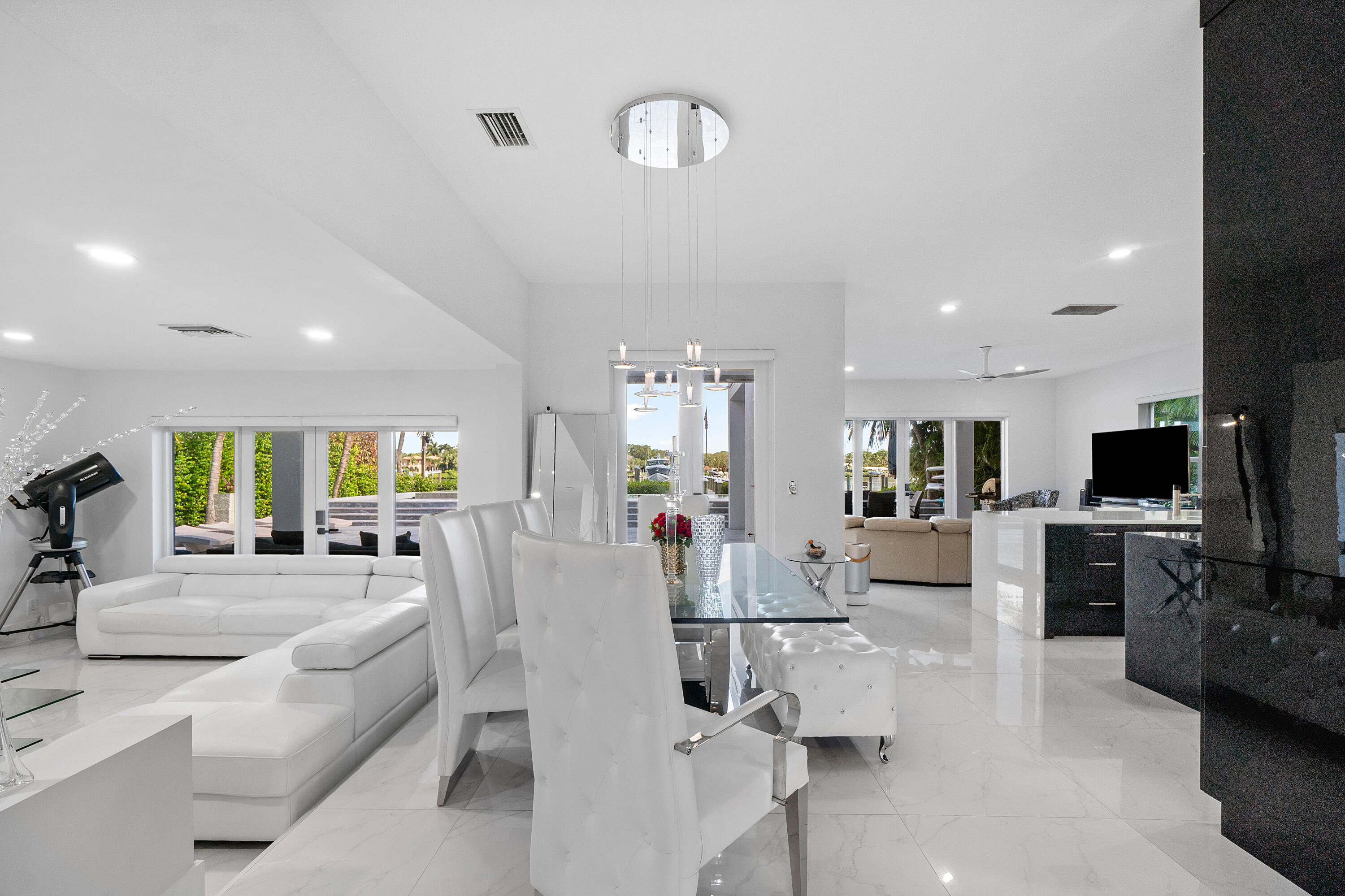 5447 Center Street Jupiter, FL 33458 - Photo 10 of 60 a living room with fireplace furniture and a flat screen tv