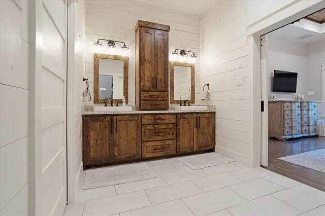 a spacious bedroom with a bed and a dresser