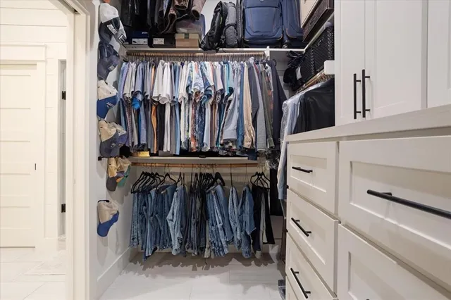 a spacious bathroom with a granite countertop sink and a mirror