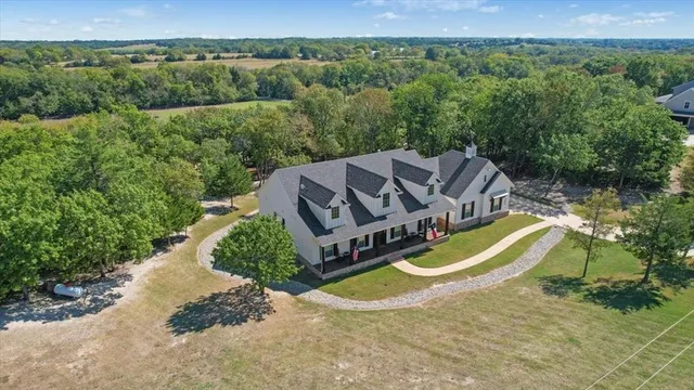 an aerial view of a house with a swimming pool