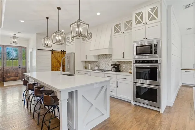 a view of a kitchen area with furniture and wooden floor