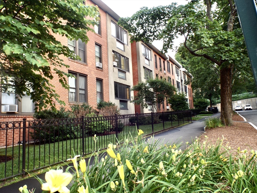 a view of a house with a yard and a garden