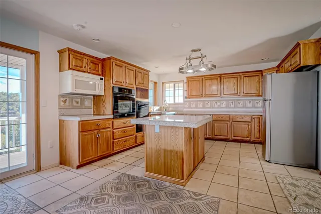 a kitchen with stainless steel appliances granite countertop a stove top oven a sink dishwasher and granite countertops with cabinets