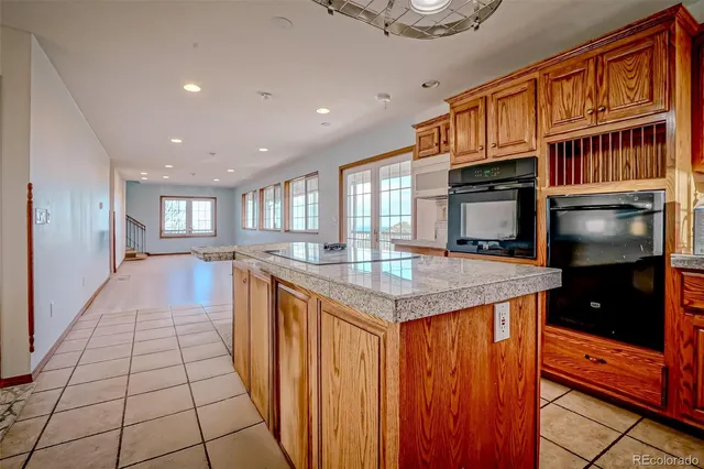 a kitchen with stainless steel appliances granite countertop a refrigerator and a stove