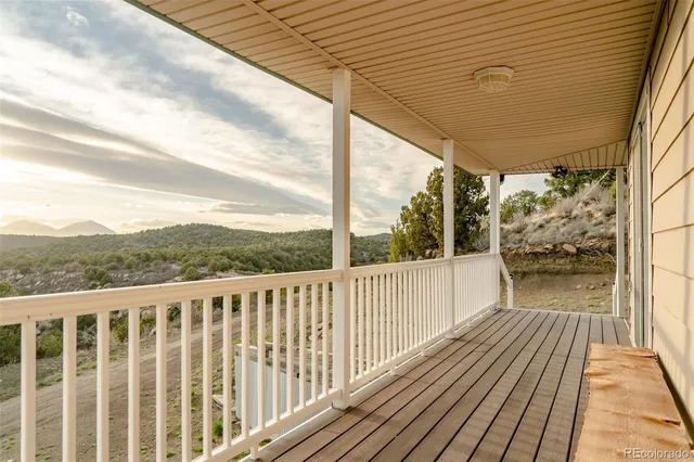 a view of balcony with wooden floor