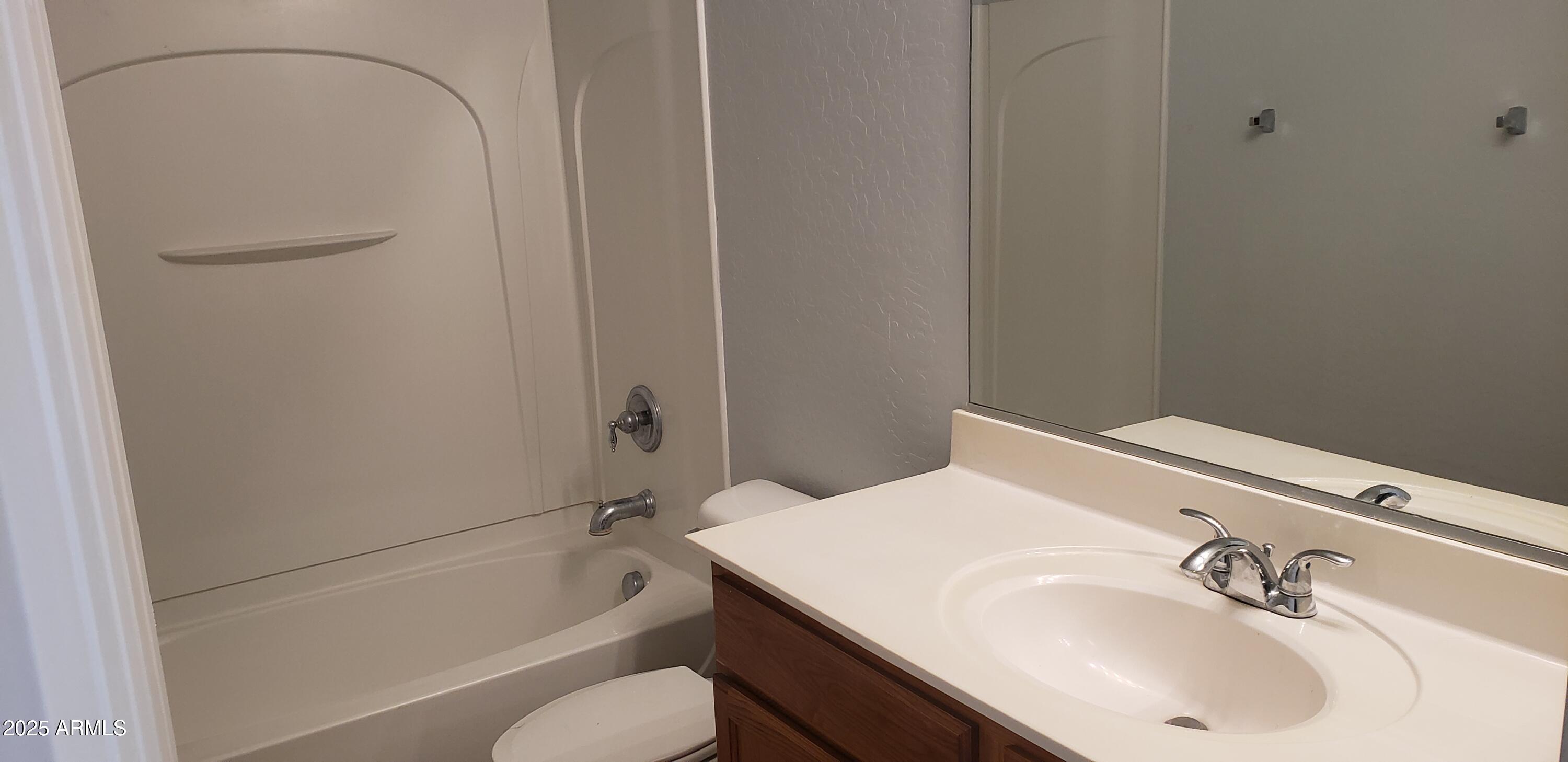 4631 West Shumway Farm Road Laveen, AZ 85339 - Photo 16 of 16 a bathroom with a sink and a bathtub