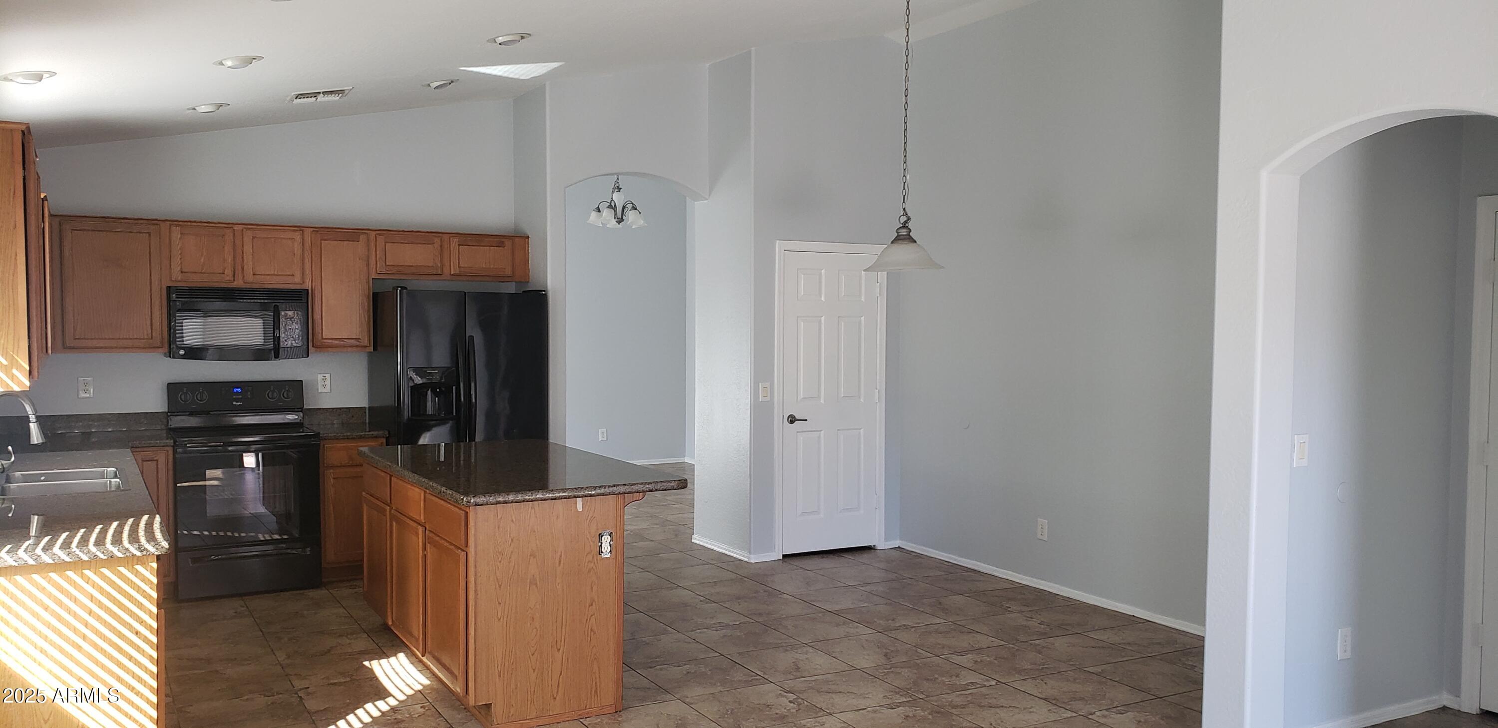 4631 West Shumway Farm Road Laveen, AZ 85339 - Photo 4 of 16 a kitchen with stainless steel appliances granite countertop a refrigerator and a sink