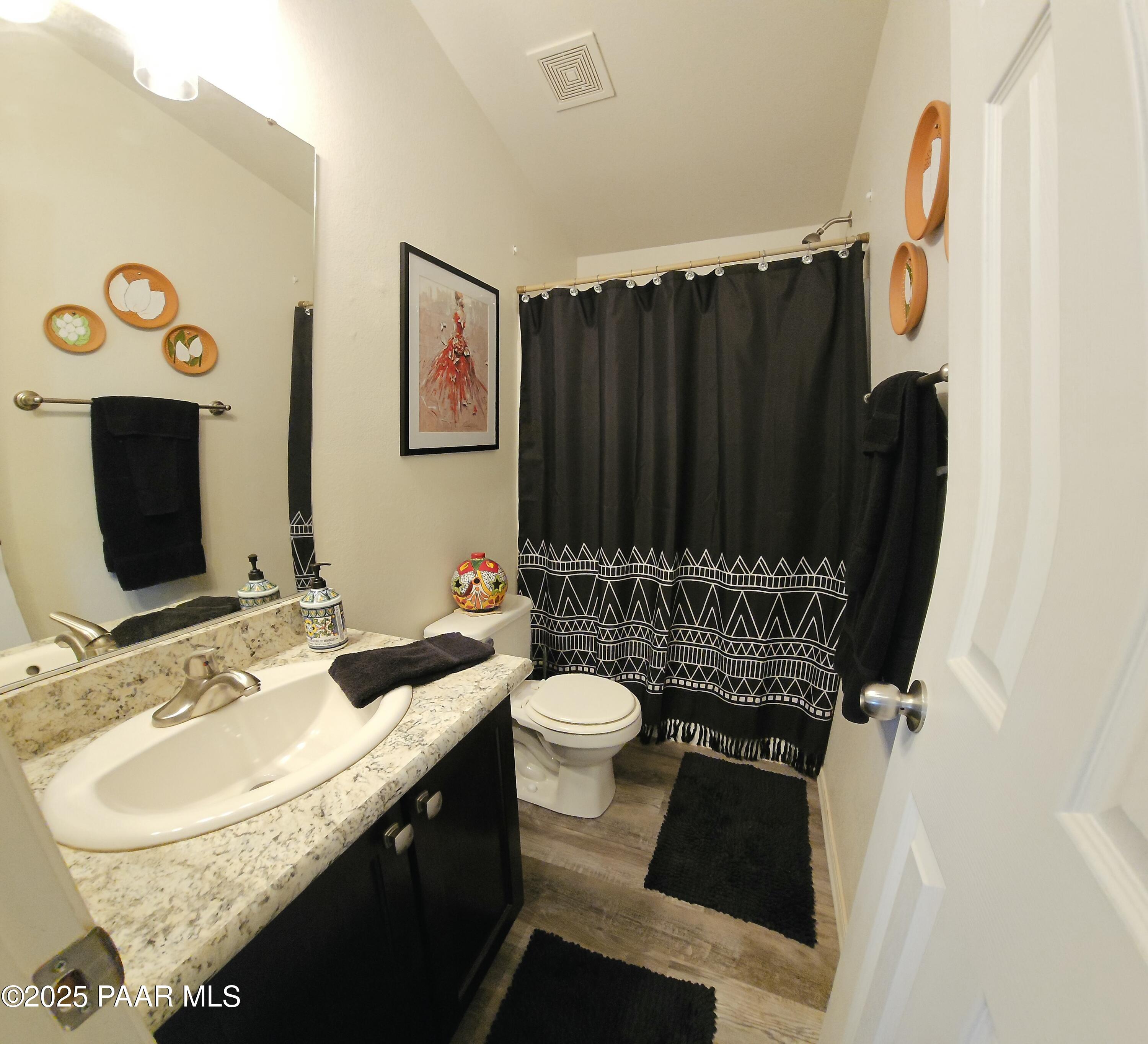 8850 West Fountain Ranch Road Ash Fork, AZ 86320 - Photo 12 of 29 a bathroom with a granite countertop sink and a mirror
