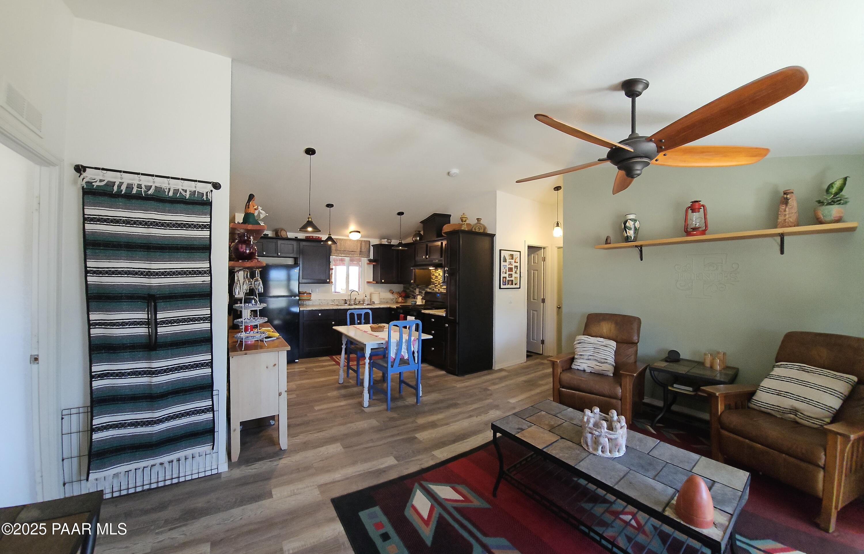 8850 West Fountain Ranch Road Ash Fork, AZ 86320 - Photo 3 of 29 a view of a workspace with furniture and wooden floor
