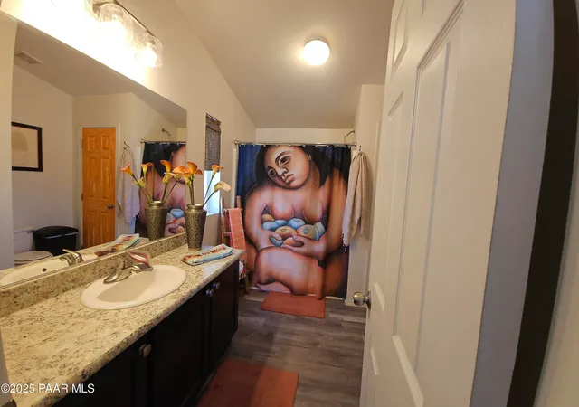 a bathroom with a toilet and a mirror