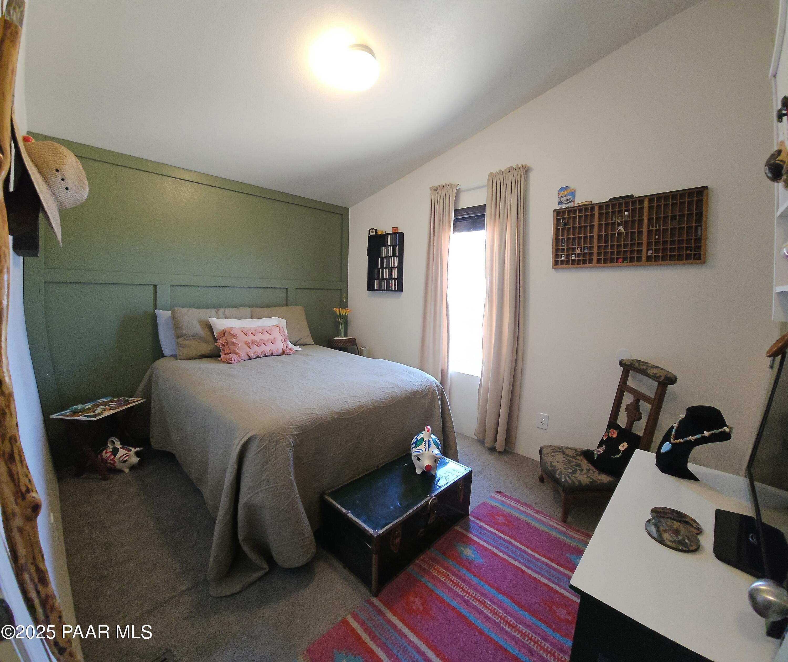 8850 West Fountain Ranch Road Ash Fork, AZ 86320 - Photo 9 of 29 a bedroom with a bed and wooden floor