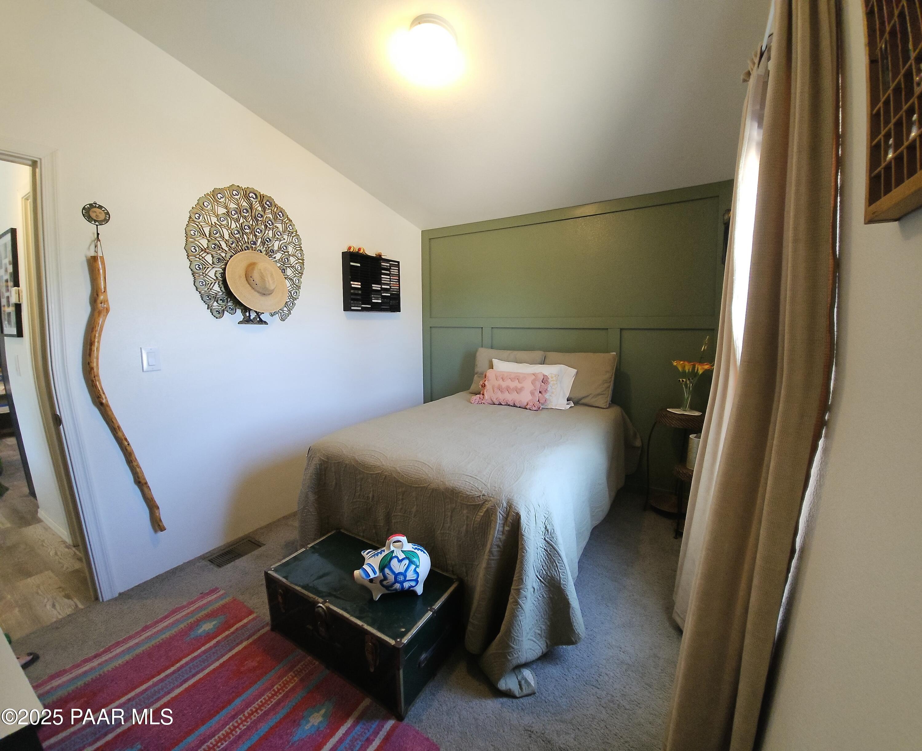 8850 West Fountain Ranch Road Ash Fork, AZ 86320 - Photo 10 of 29 a bedroom with a bed and a table with rug