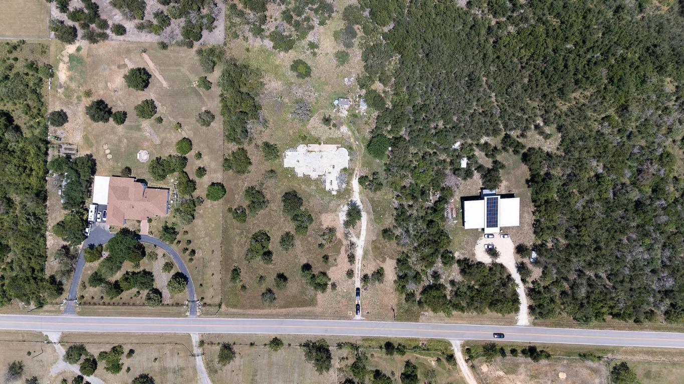 7693 Nez Perce Trace Manor, TX 78653 - Photo 2 of 12 view of a yard with wooden fence and plants