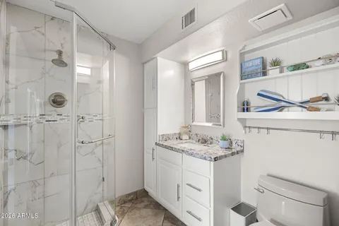 a bathroom that has a glass shower door