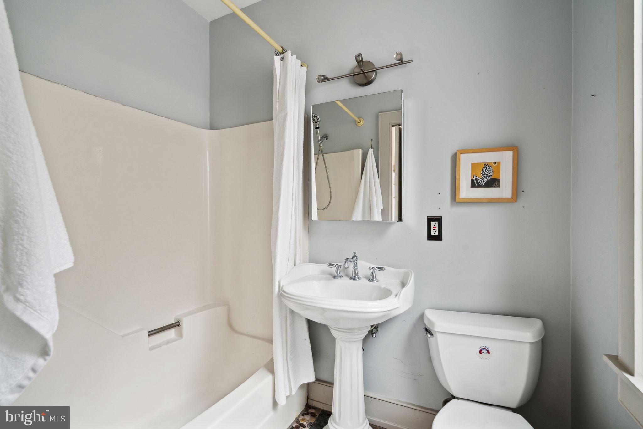 2206 Wallace Street Philadelphia, PA 19130 - Photo 12 of 38 a bathroom with a toilet sink and mirror