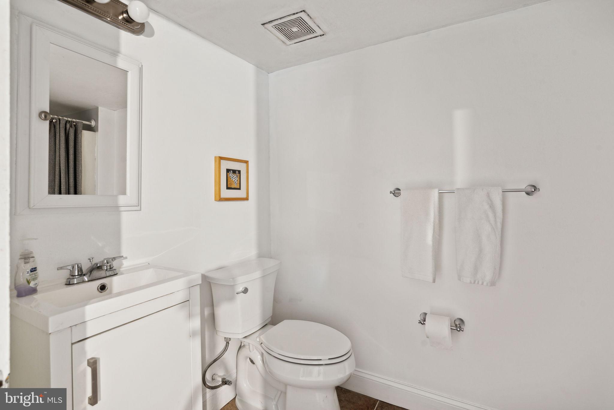 2206 Wallace Street Philadelphia, PA 19130 - Photo 16 of 38 a bathroom with a sink a toilet and a mirror