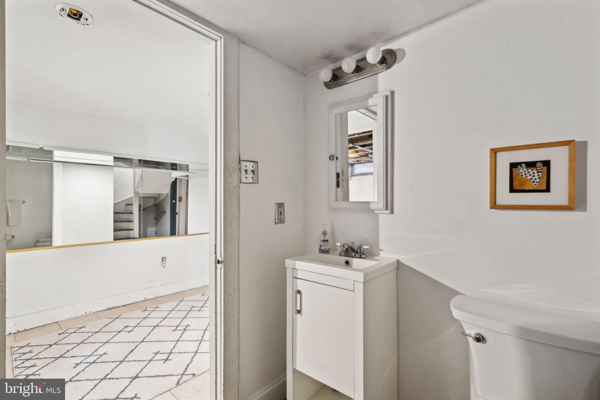 2206 Wallace Street Philadelphia, PA 19130 - Photo 17 of 38 a bathroom with a sink a toilet and shower