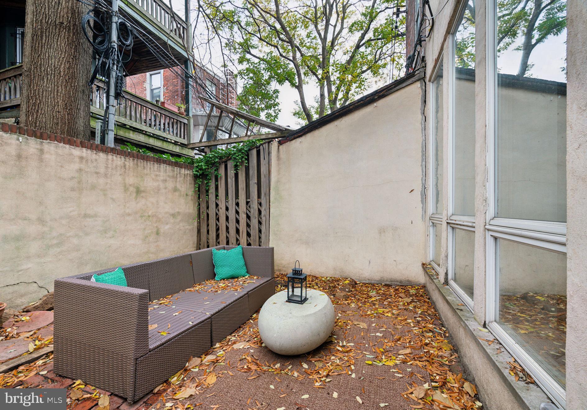 2206 Wallace Street Philadelphia, PA 19130 - Photo 22 of 38 a backyard of a house with seating space