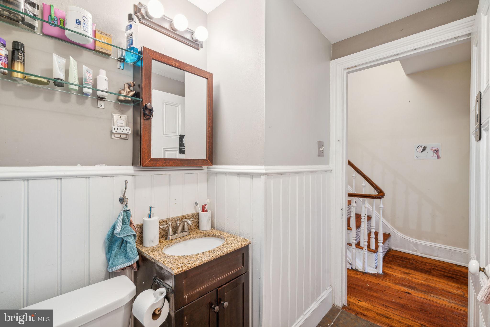 2206 Wallace Street Philadelphia, PA 19130 - Photo 27 of 38 a bathroom with a sink a mirror and a vanity