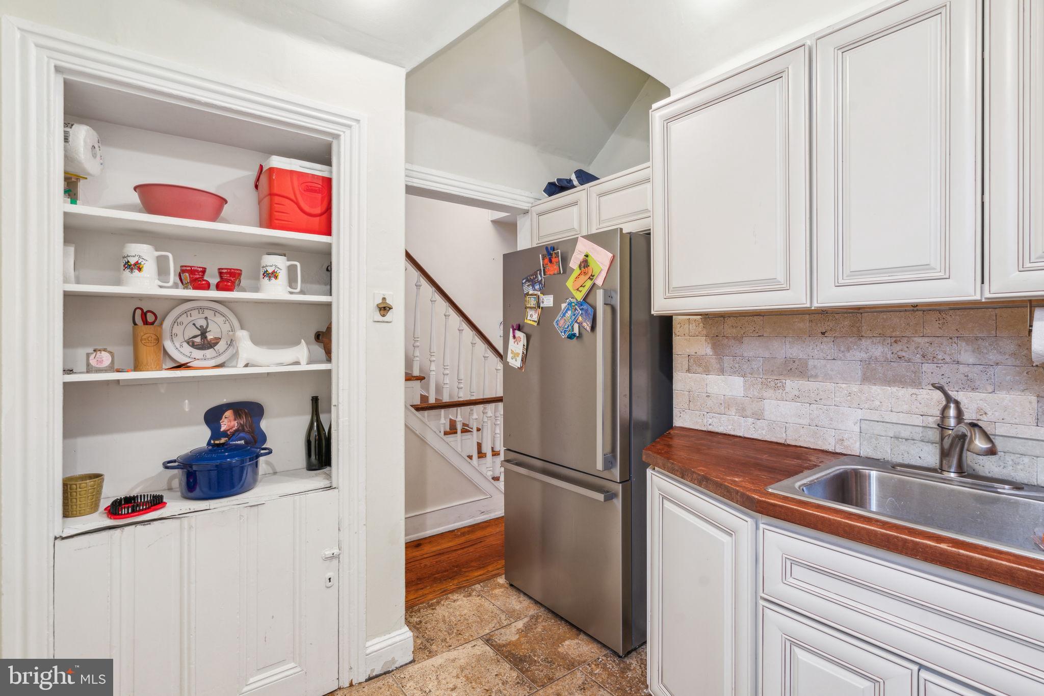 2206 Wallace Street Philadelphia, PA 19130 - Photo 28 of 38 a kitchen with a refrigerator and cabinets