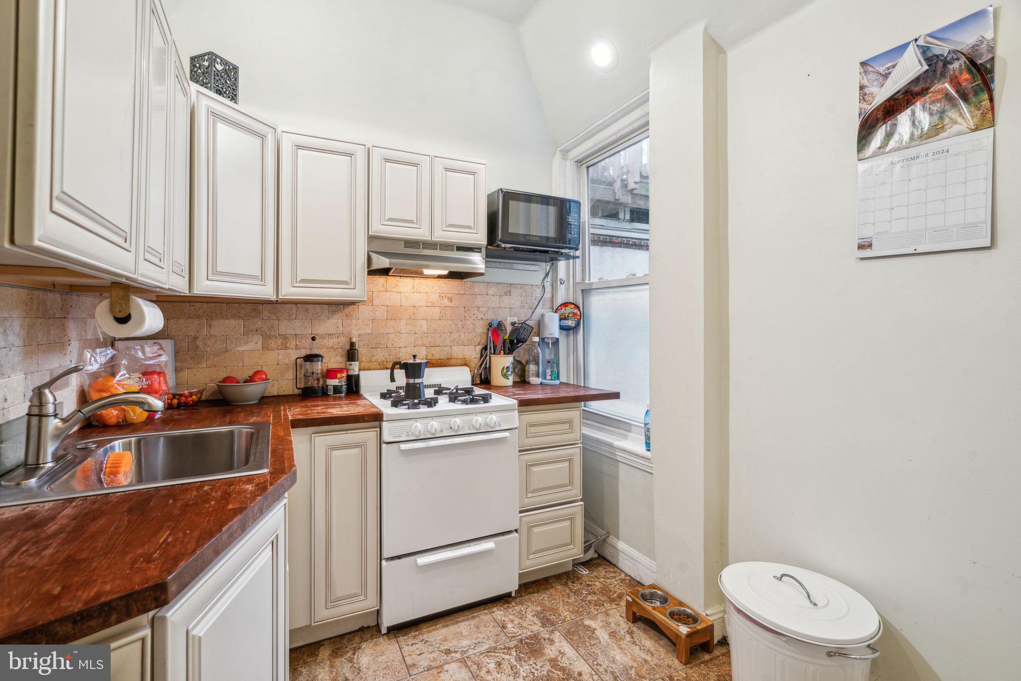 2206 Wallace Street Philadelphia, PA 19130 - Photo 29 of 38 a kitchen with a sink stove and cabinets