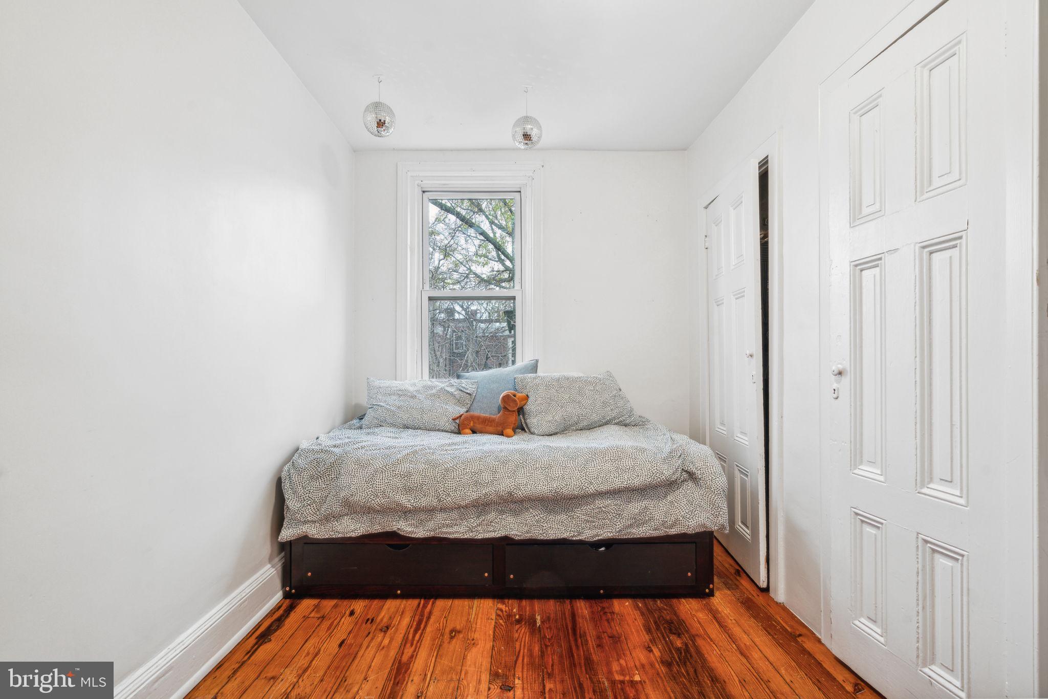 2206 Wallace Street Philadelphia, PA 19130 - Photo 32 of 38 a bedroom with a bed and wooden floor