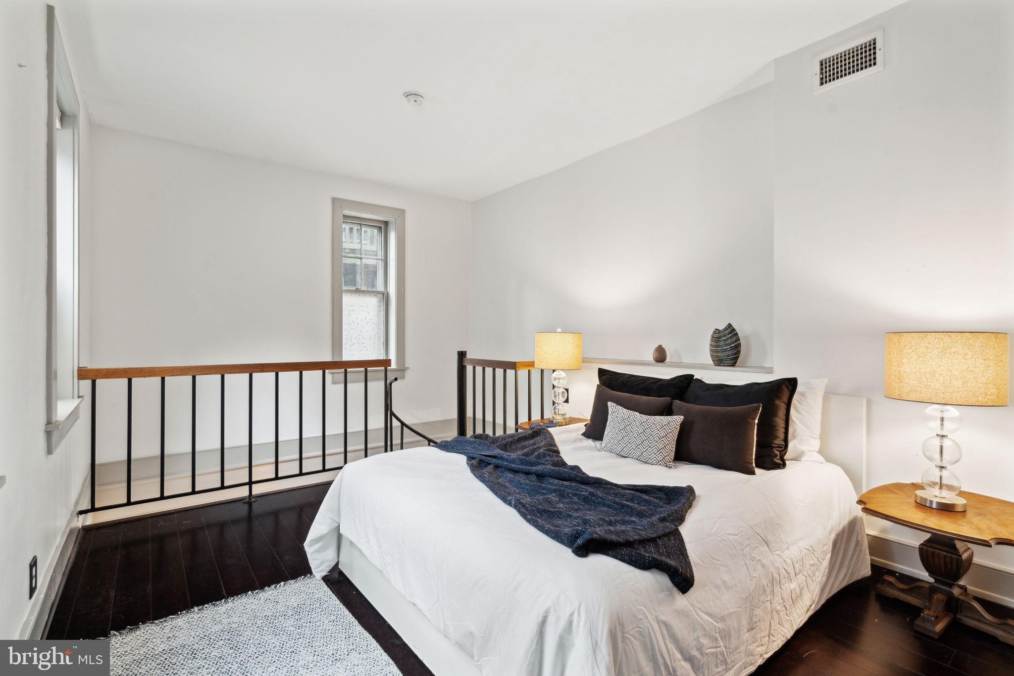 2206 Wallace Street Philadelphia, PA 19130 - Photo 10 of 38 a bedroom with a bed and lamp