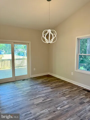 a view of balcony with wooden floor and fence and trees