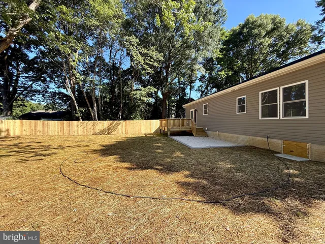 a backyard of a house with wooden fence