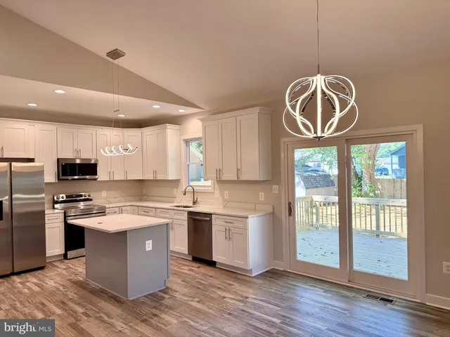 a kitchen with a stove a refrigerator and a sink